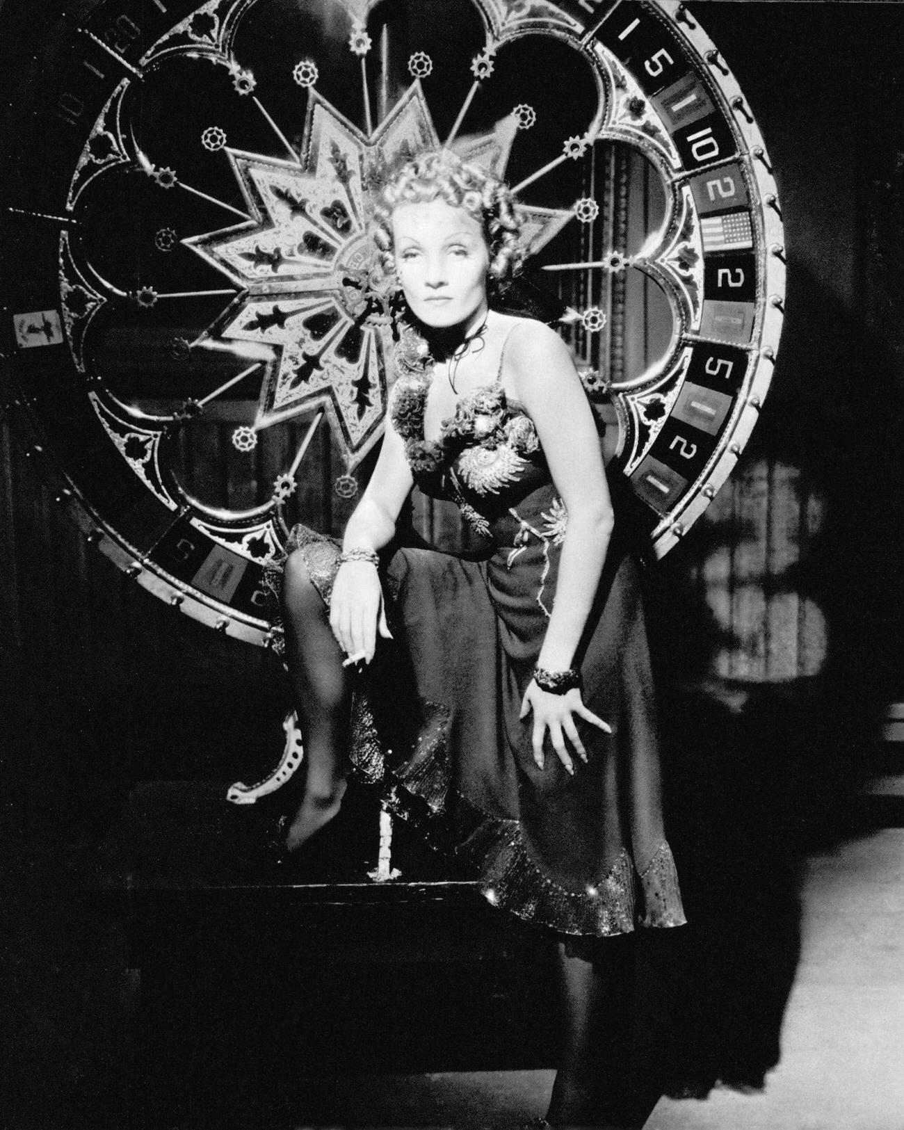 Marlene Dietrich As Frenchy, Standing By A Large Roulette Wheel In A Publicity Still For 'Destry Rides Again', Directed By George Marshall, 1939