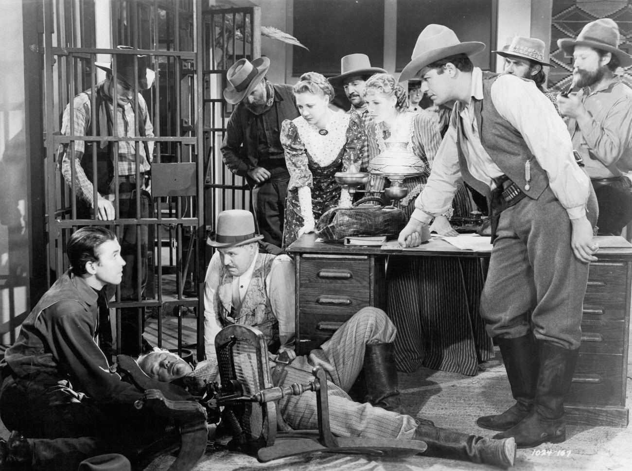 James Stewart Kneeling Down Beside Fallen Man Beside Jail Cell In A Scene From The Film 'Destry Rides Again', 1939.