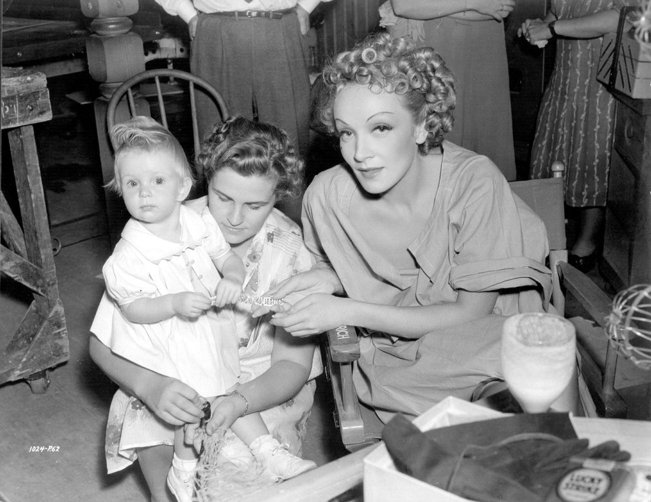Child Star Baby Sandy Visits Marlene Dietrich On The Set Of Her Latest Film 'Destry Rides Again.'