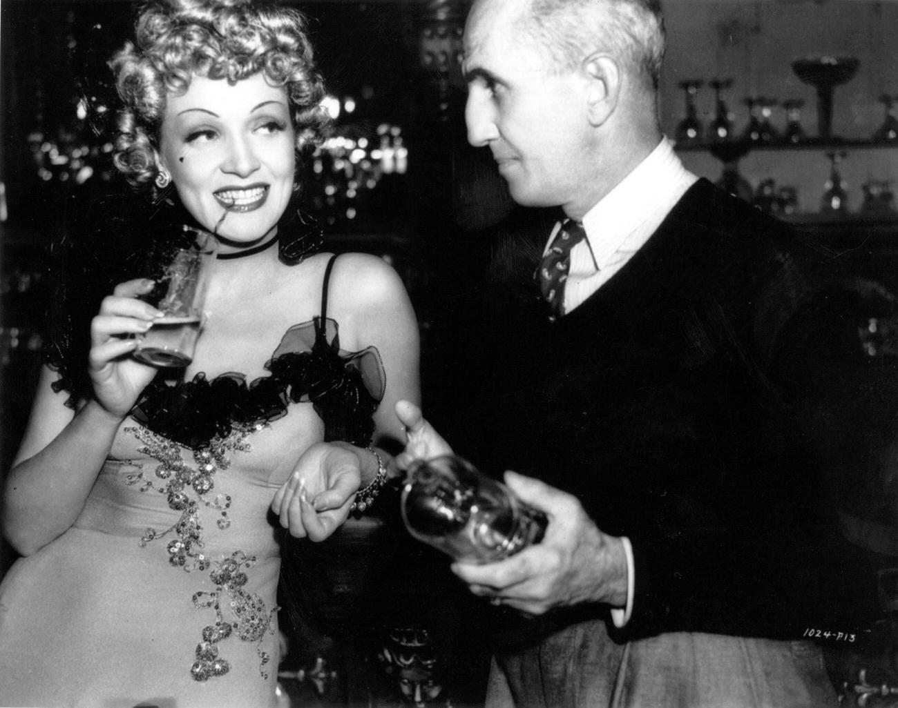 Marlene Dietrich Talks With Director George Marshall On The Set Of Their Latest Film 'Destry Rides Again'.