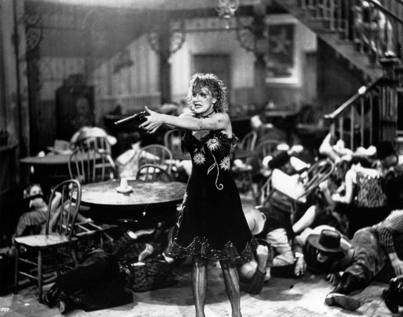 Everyone Avoids The Sights Of Marlene Dietrich'S Gun In The Film 'Destry Rides Again'