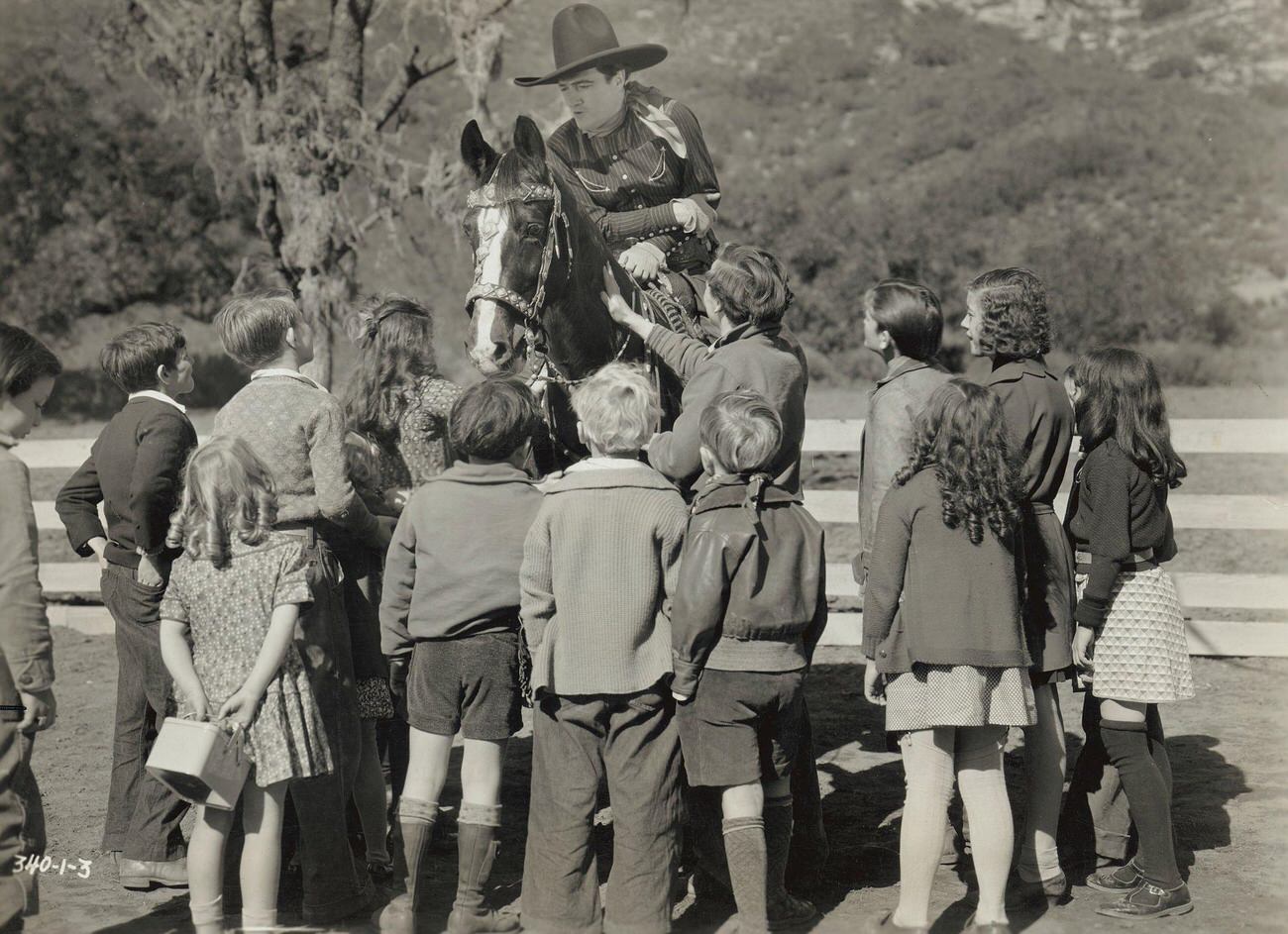 Tom Mix Visits With A Group Of School Children During The Filming Of Destry Rides Again.