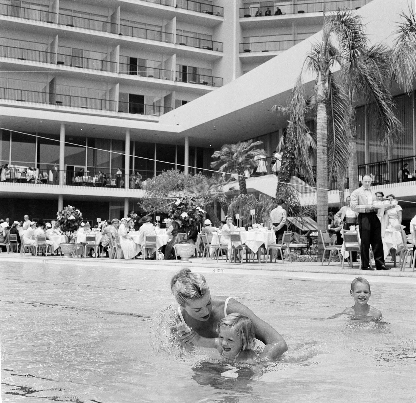 Esther Williams Teaches A Child To Swim At Swim School Opening In Los Angeles On August 12, 1955