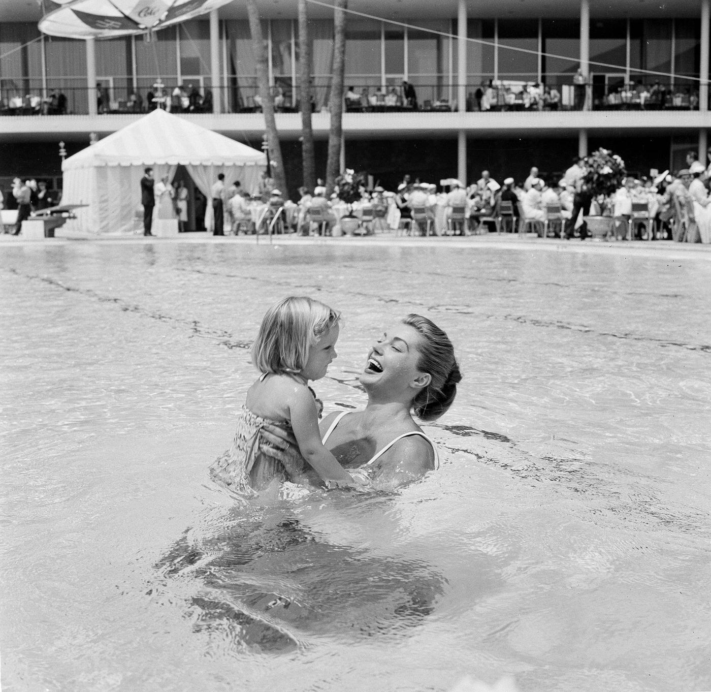 Esther Williams Holds A Child In The Pool At Swim School Opening In Los Angeles On August 12, 1955
