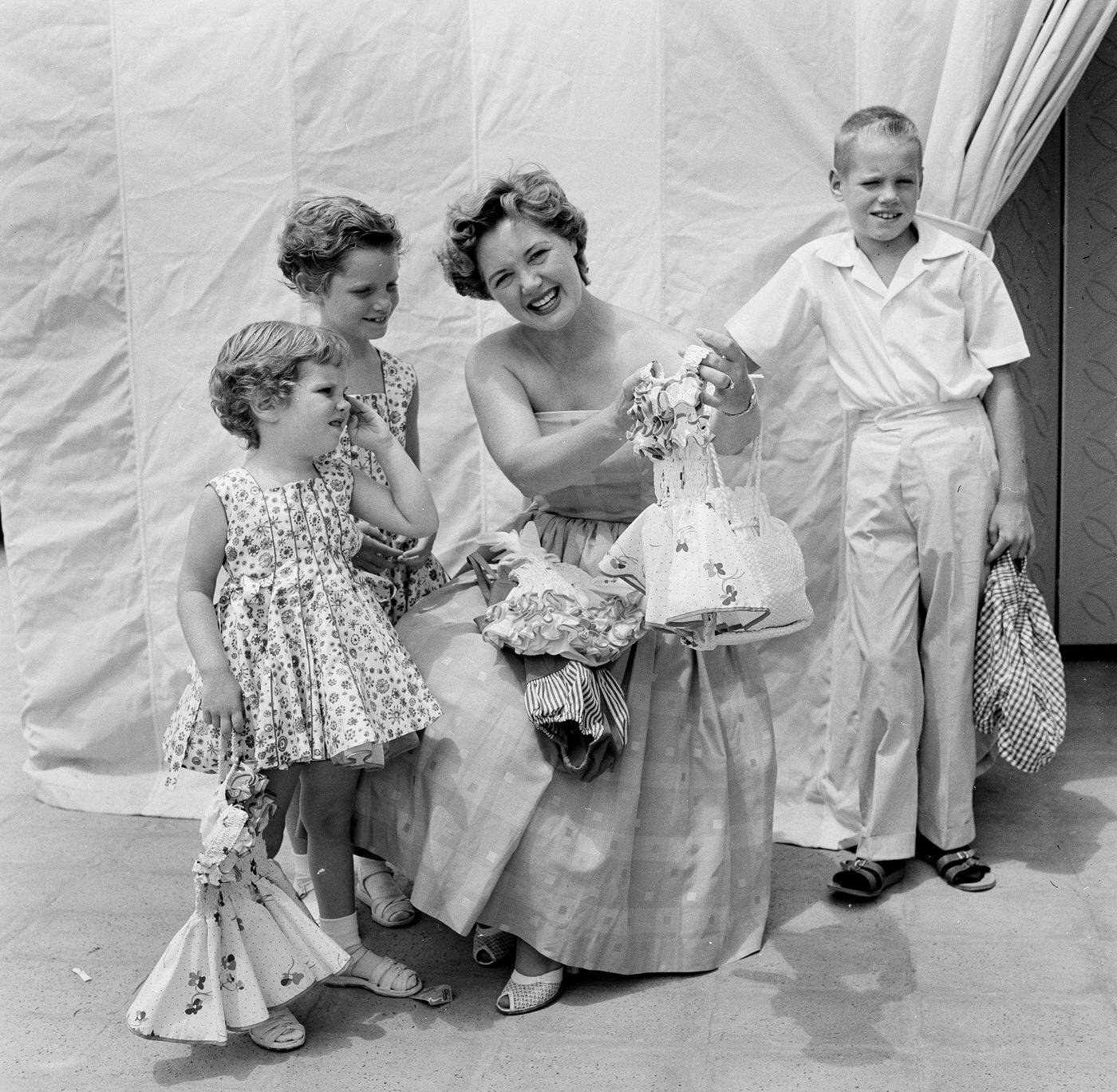 A Woman Brings Her Children To Swim School Opening In Los Angeles On August 12, 1955
