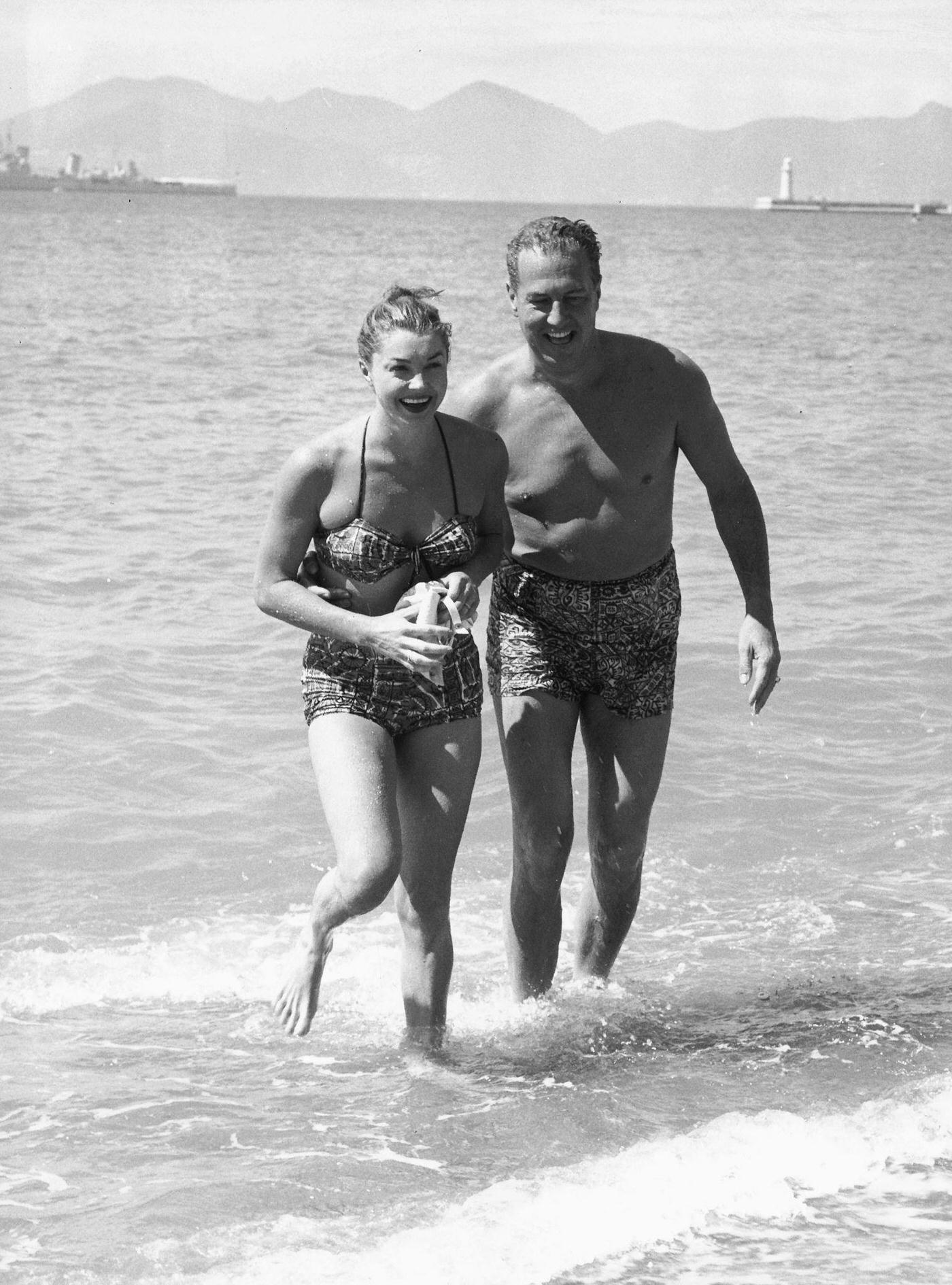 Esther Williams And Her Husband Ben Gage Walking Out Of The Sea Following A Swim, At The Place Martinez Beach In Cannes, May 12Th 1955