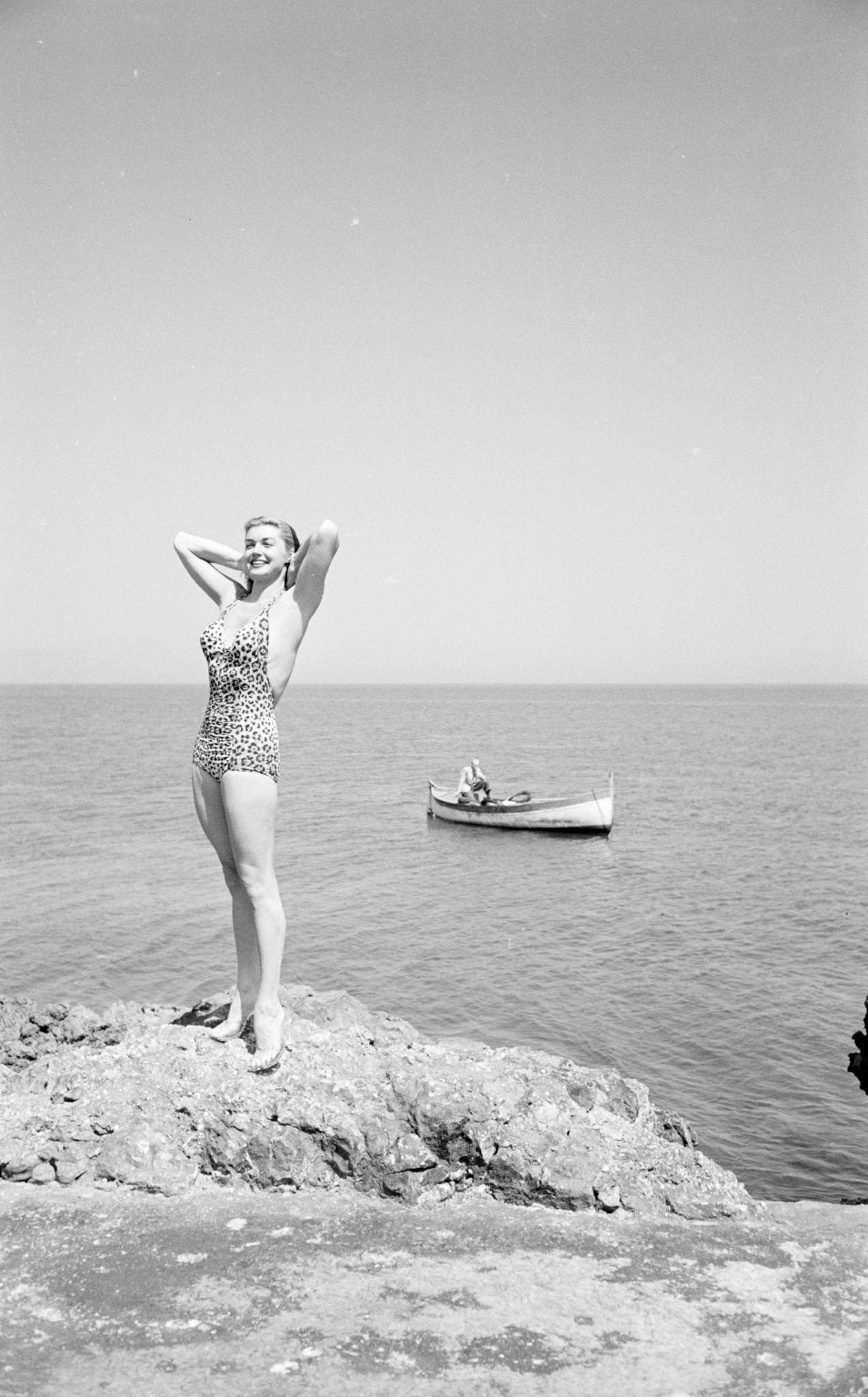 Esther Williams Smiling And Standing On A Rock