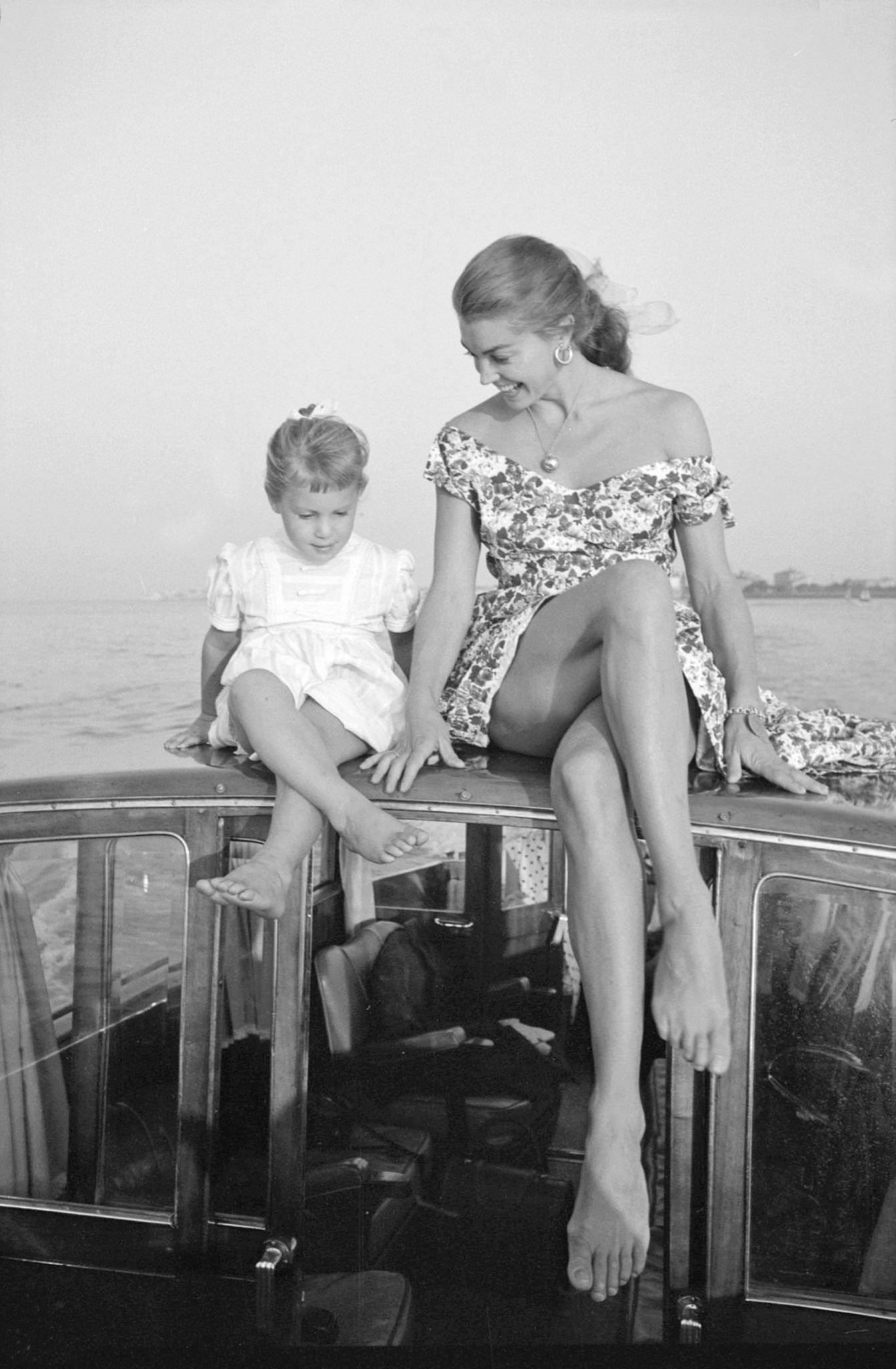Esther Williams Sitting On A Boat And Teaching A Little Girl How To Cross Her Legs During The Xviii Venice International Film Festival. Venice, 1957