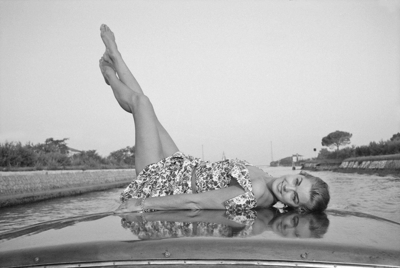 Esther Williams Lying On A Boat With Her Legs Up In The Air During The Xviii Venice International Film Festival. Venice, 1957