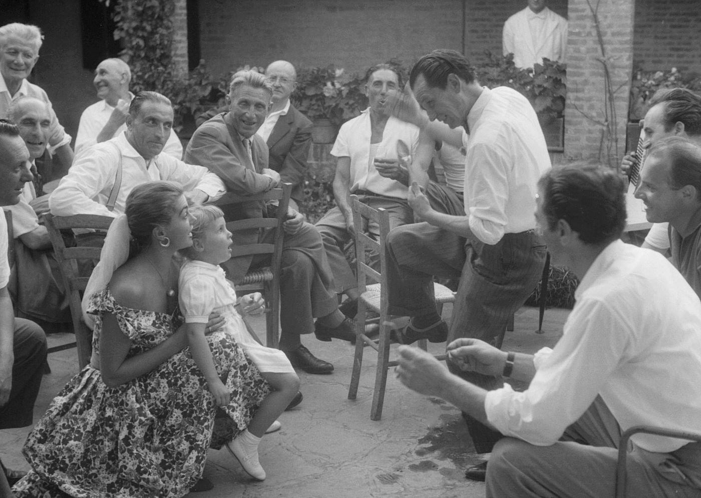 Esther Williams Watching A Man Dancing In The Street During The Xviii Venice International Film Festival. Venice, 1957
