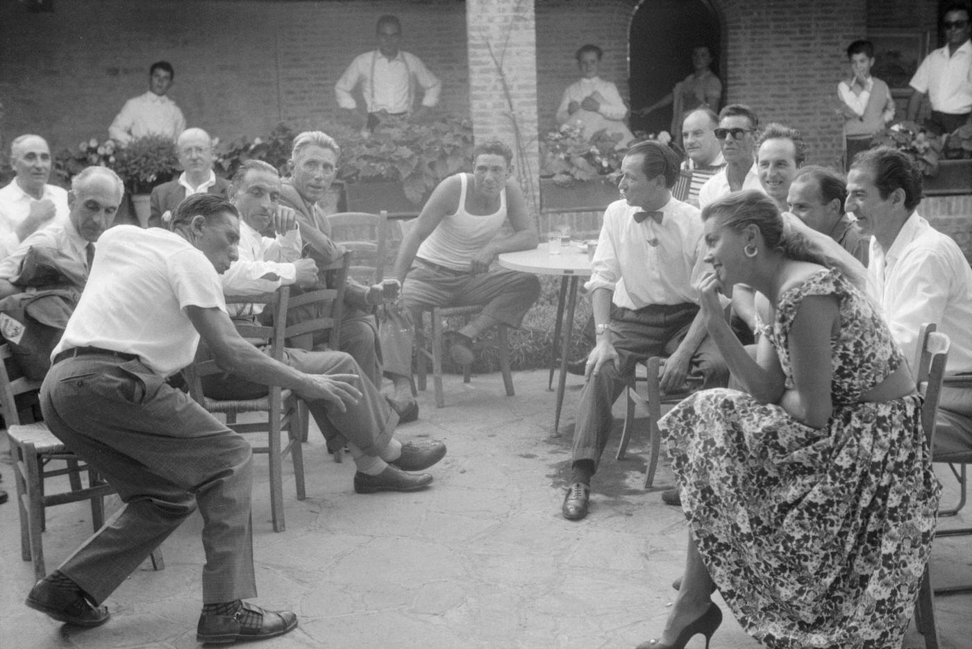 Esther Williams Watching A Man Dancing In The Street During The Xviii Venice International Film Festival. Venice, 1957