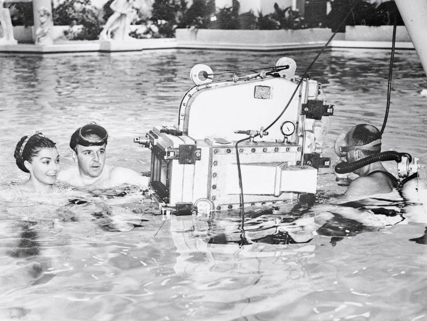 Esther Williams Listens To Explanations From Director George Sidney About The Underwater Camera That Will Photograph The Actress In Jupiter'S Darling,