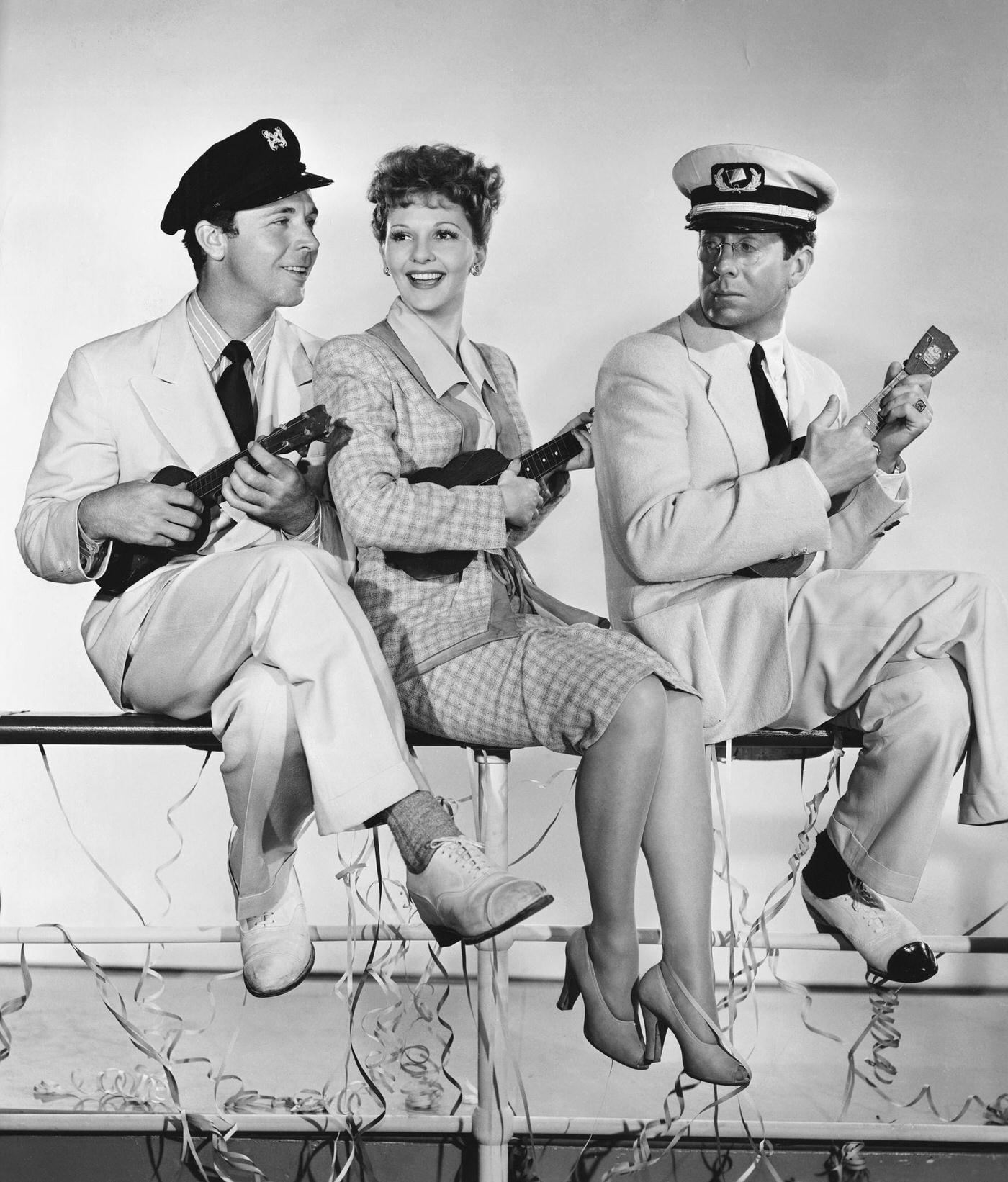 Dick Powell As Pete Hamilton, Mary Martin As Marjory Stuart, And Rudy Vallee As Alfred Monroe In The 1943 Musical Comedy Happy Go Lucky.