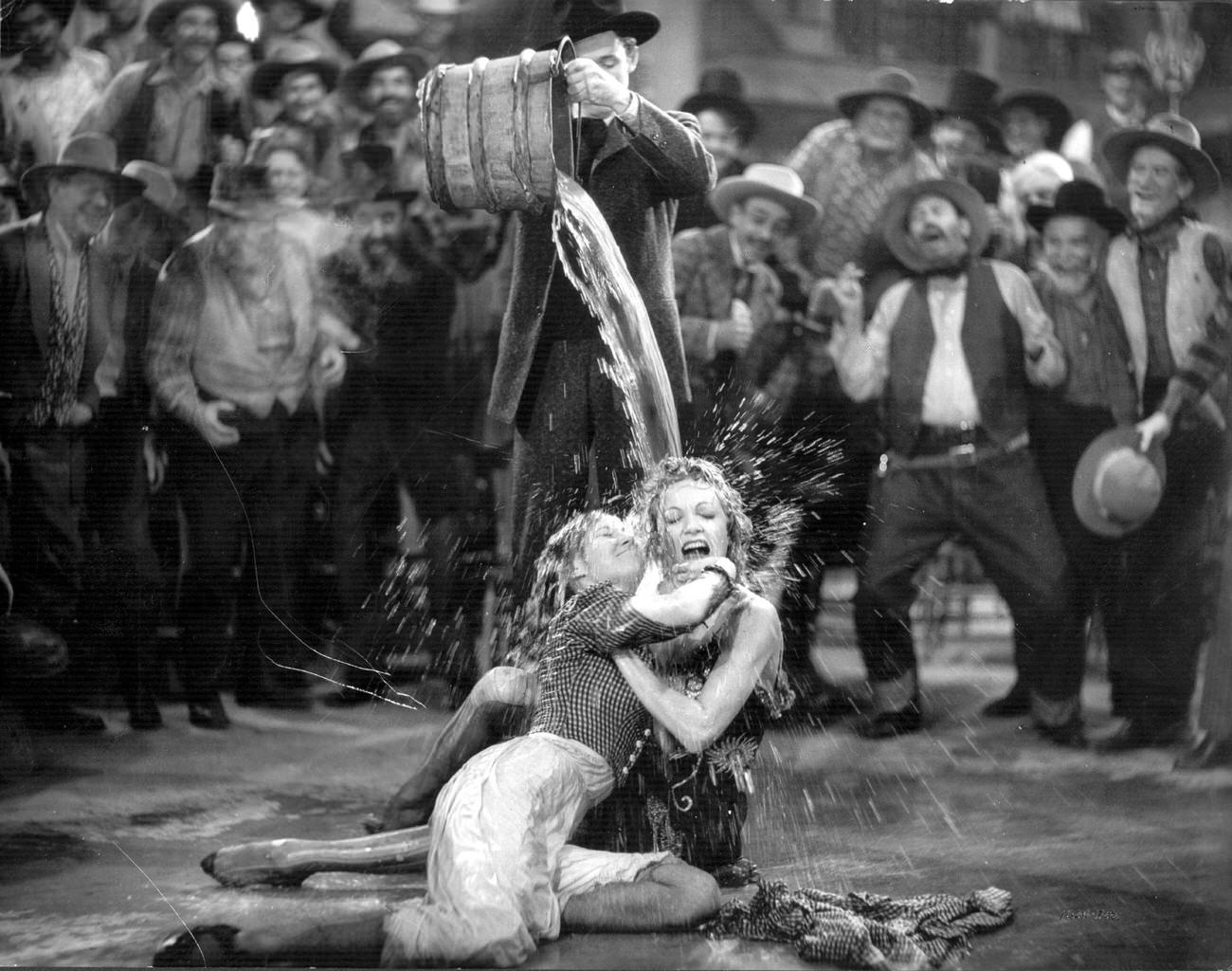 James Stewart Effectively Breaks Up A Fight Between Una Merkel And Marlene Dietrich By Pouring A Bucket Of Water Over Them, In The Classic Western 'Destry Rides Again'.