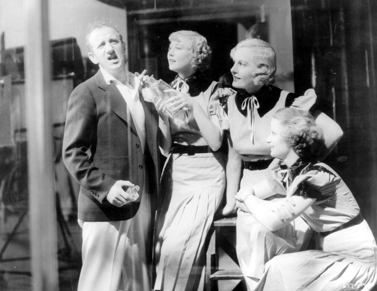 Merkel, Madge Evans And Florine Mckinney Test Out Their Special Perfume On Jimmy Durante In A Scene From 'Beauty For Sale'