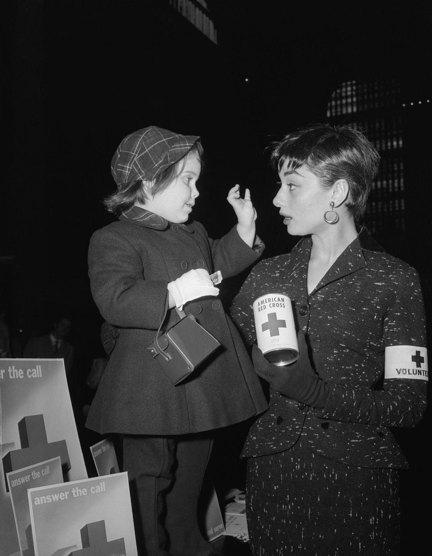 Audrey Hepburn Holds A Quick Conference With Peggy Ann Malone, The Three Year Old Daughter Of Mr. And Mrs. Robert Malone, Of Bronxville,