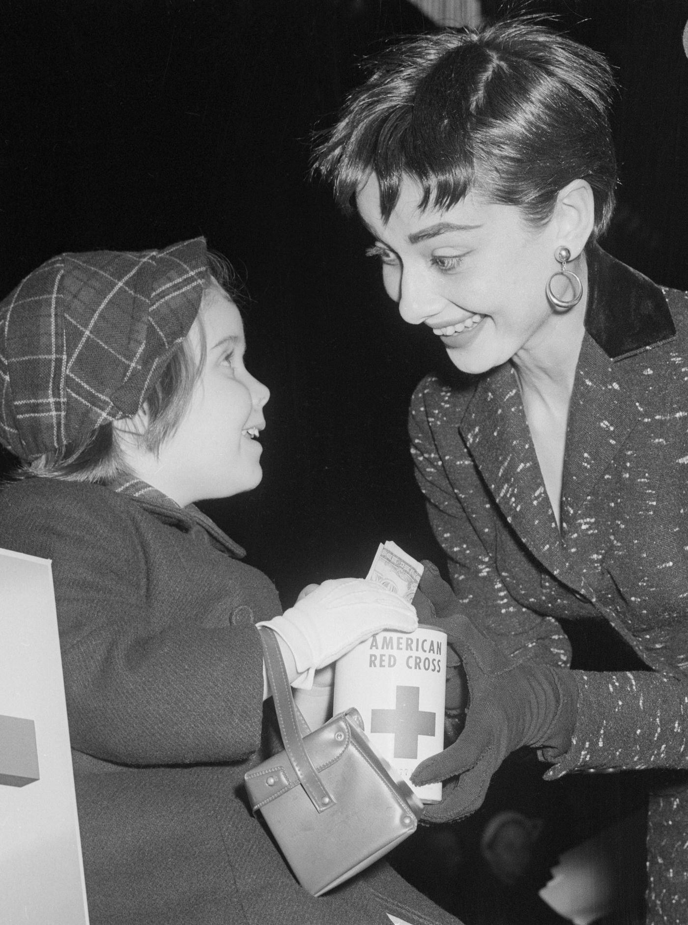 Audrey Hepburn With Girl Donating To Red Cross