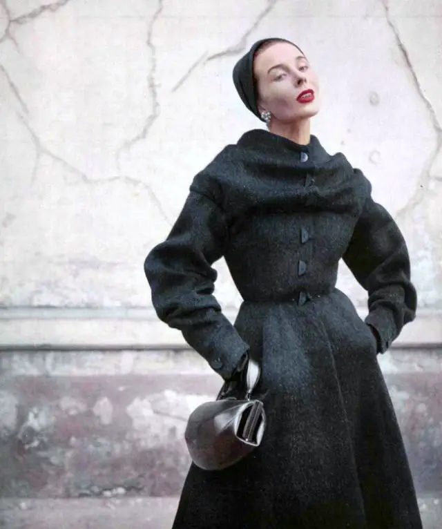Bettina In Furry Wool Redingote With Cape-Like Shawl Clasped Over Shoulders, Fastened With Whimsical Half Buttons, By Jean Dessès, 1952