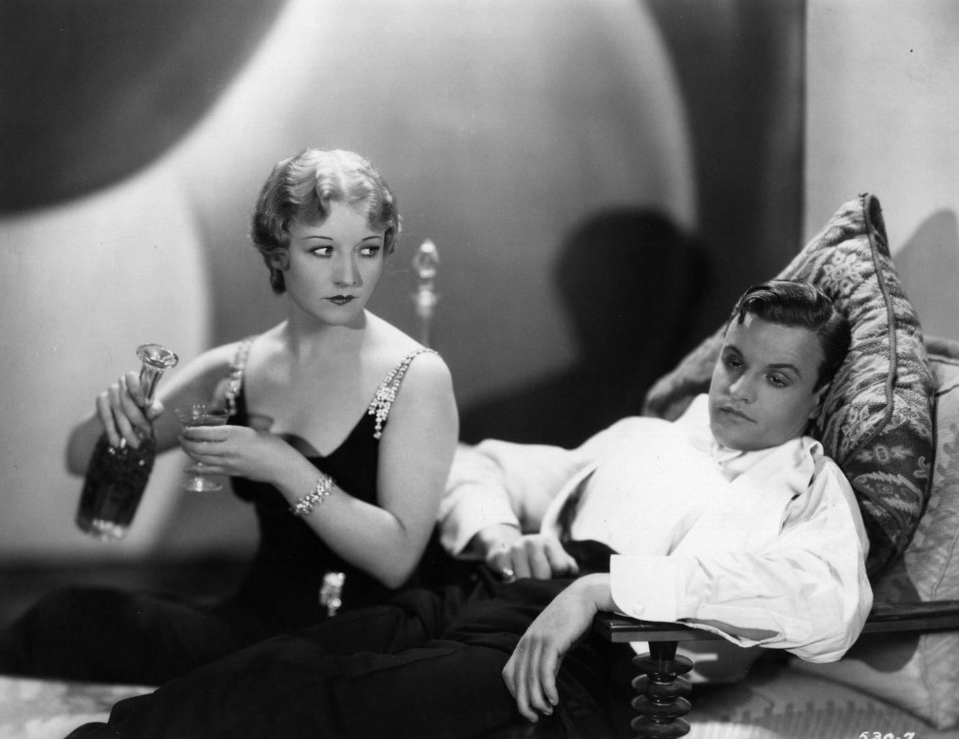 Betty Compson Pours A Drunken Looking John Darrow A Drink In A Clip From The Rko Film 'A Lady Refuses', 1927