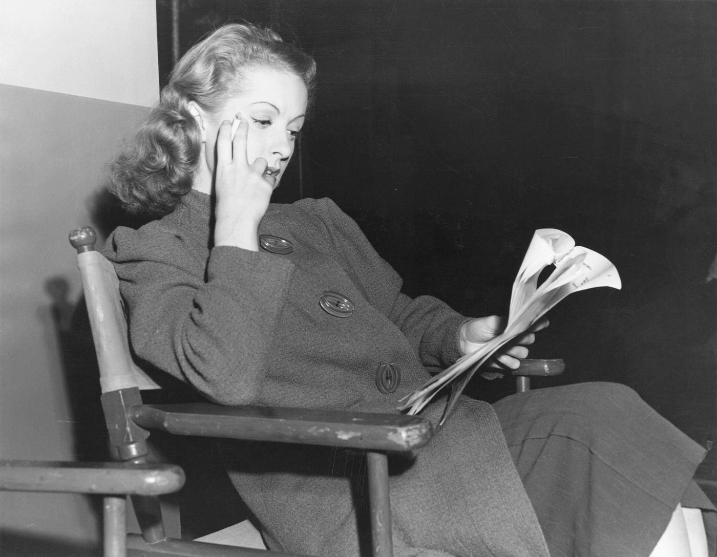 Danielle Darrieux Smokes A Cigarette While Reading Over The Rage Of Paris Script During A Break