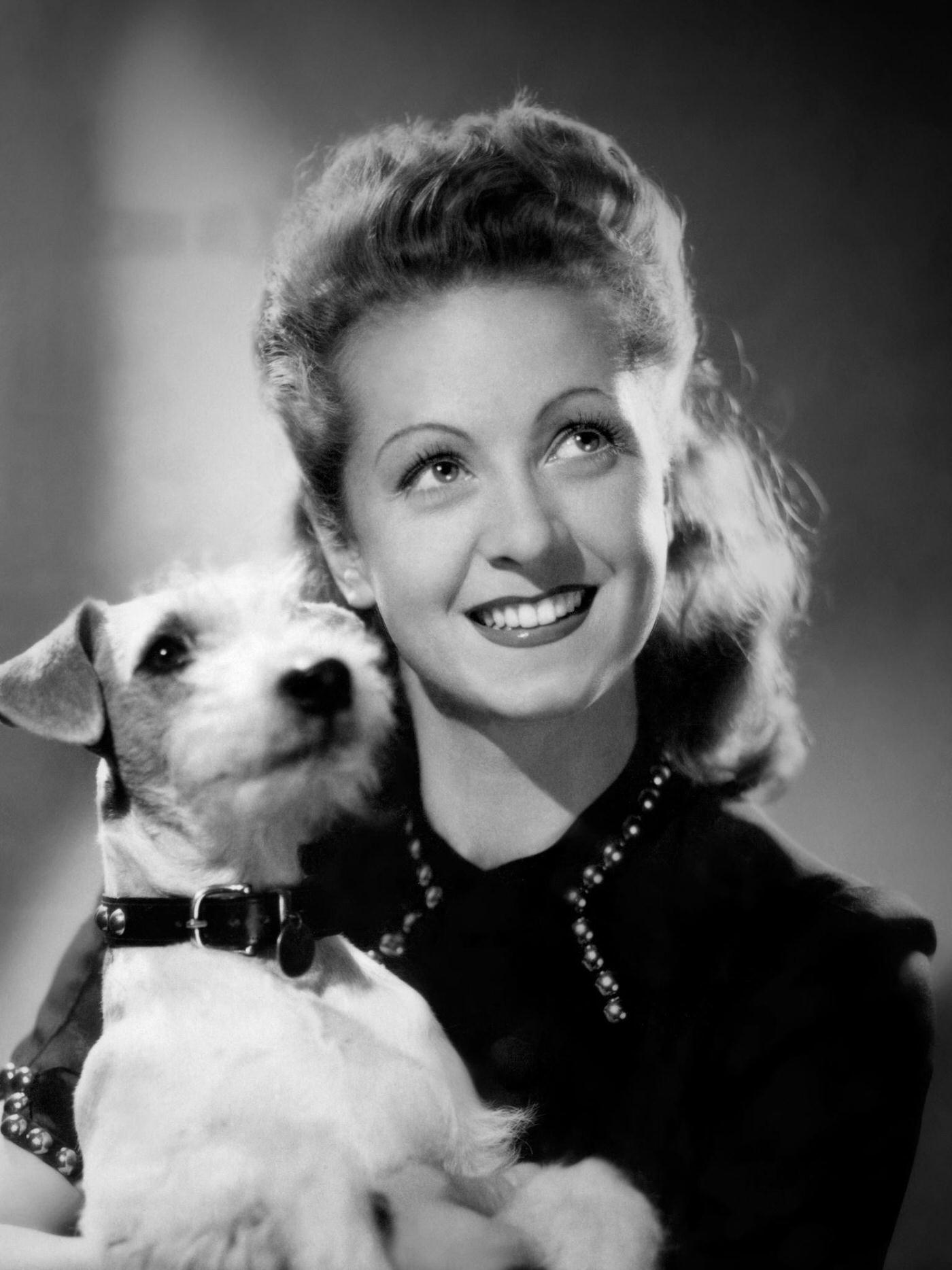 Danielle Darrieux Posing With A Dog.