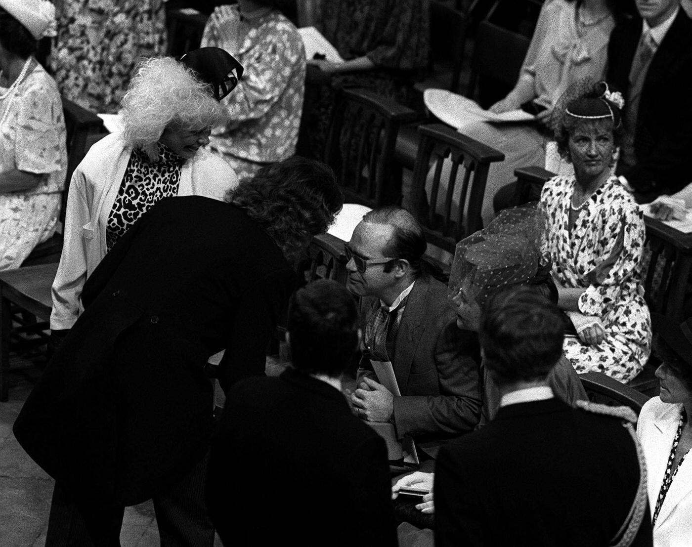 Elton John And His Wife, Renate Blauel, Chat In Westminster Abbey, London, After The Royal Wedding Of The Duke Of York And Sarah Ferguson.