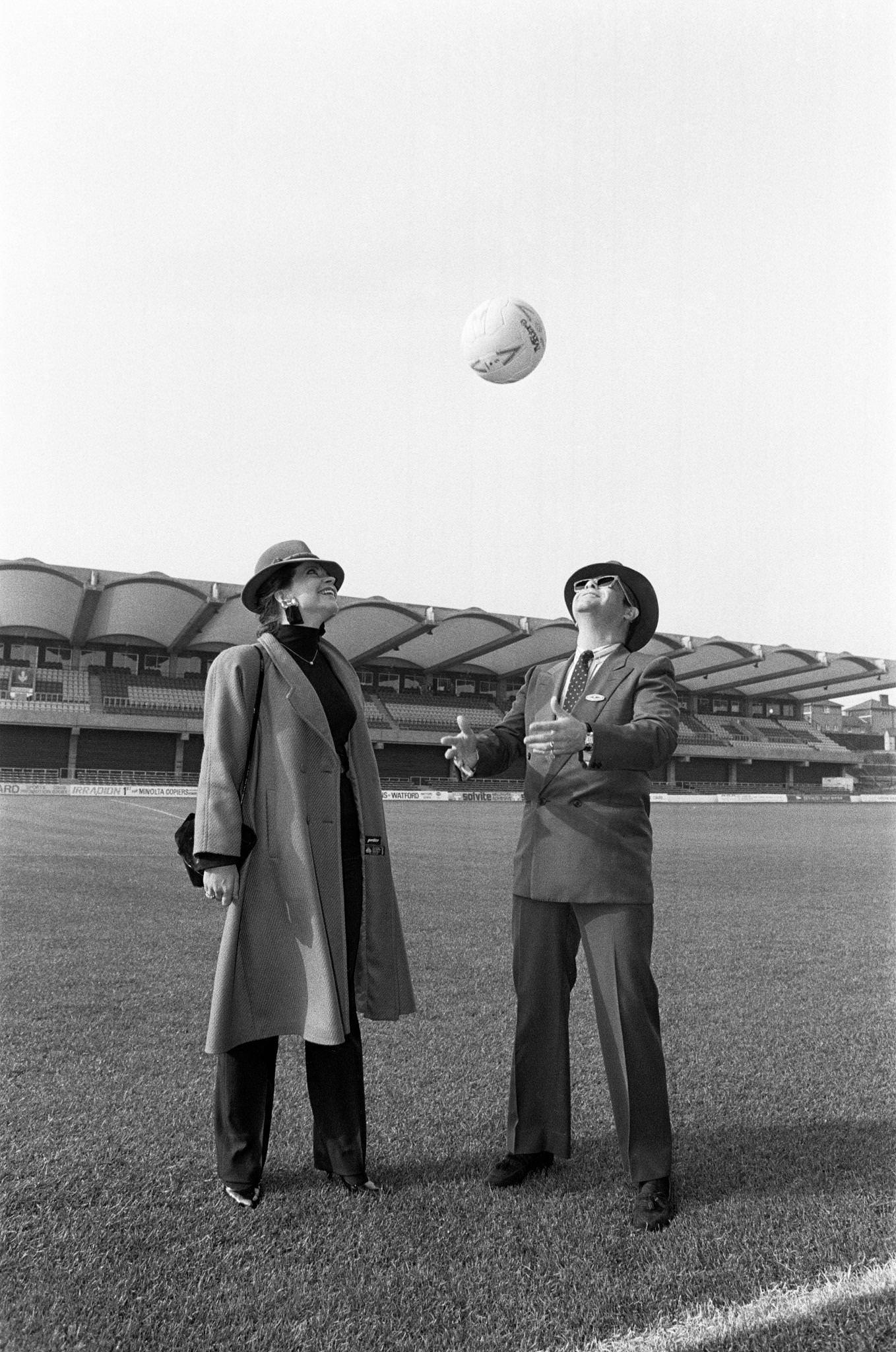 Watford Fc Chairman Elton John And Renate At Vicarage Road, Home Of Watford Football Club. Pictured In Front Of Watford'S New Stand, 18Th October 1986.
