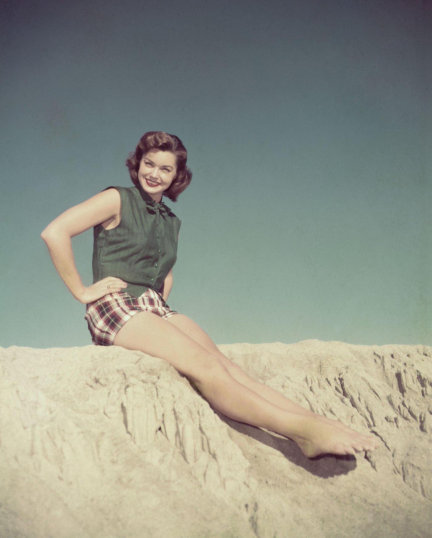 Esther William Wears These Gay Plaid Shorts Topped By A Vest Of Forest Green Linen For A Day At The Beach.