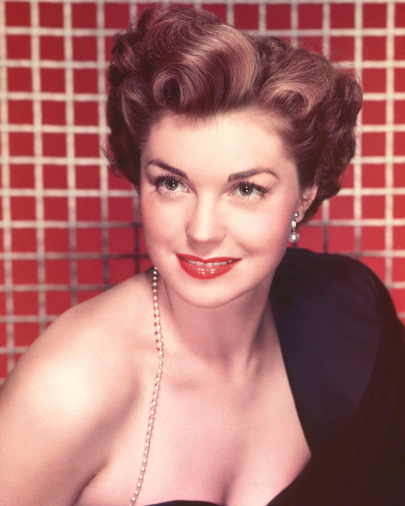 Esther Williams In A Studio Portrait, Against A Red Background, 1950.