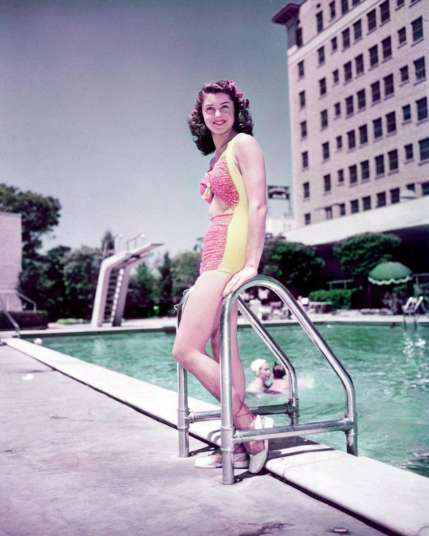 Esther Williams Wearing A Bathing Costume As She Poses Leaning Against The Ladder At The Edge Of A Swmiming Pool, 1945.