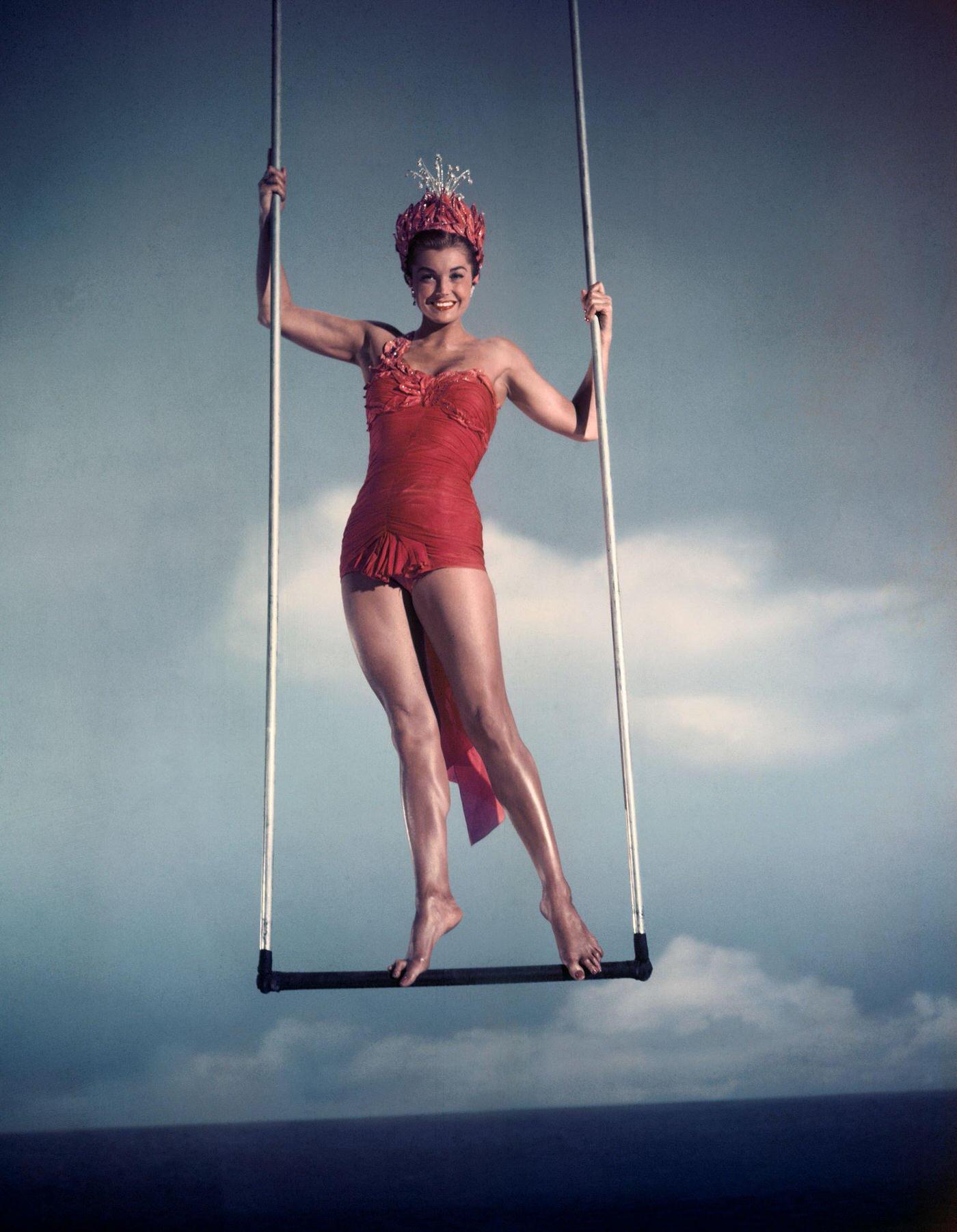 Esther William Smiles As She Swings From Trapeze.