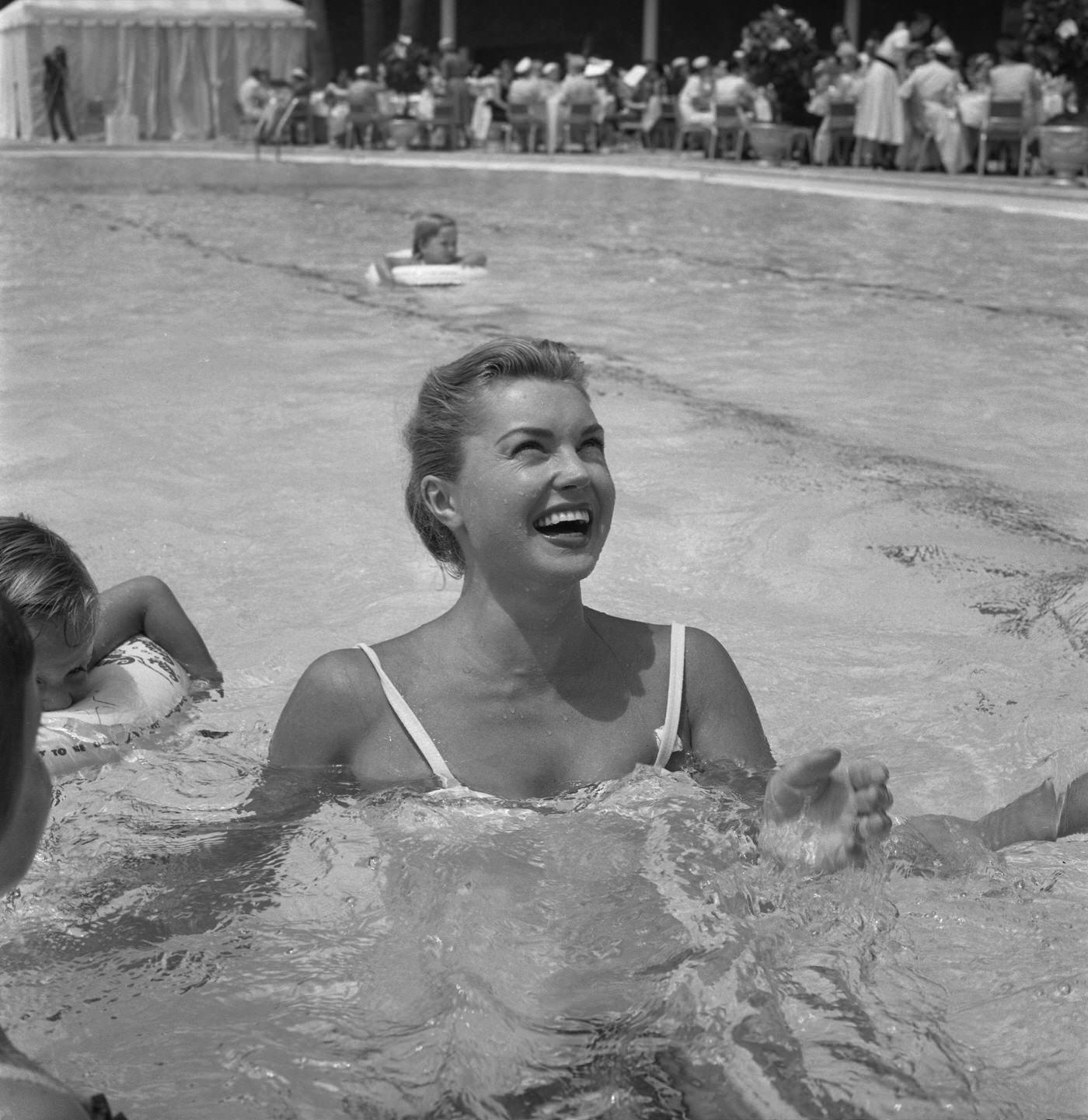 Esther Williams Gives Swimming Lessons In The Pool At The Hilton Hotel On August 9, 1955