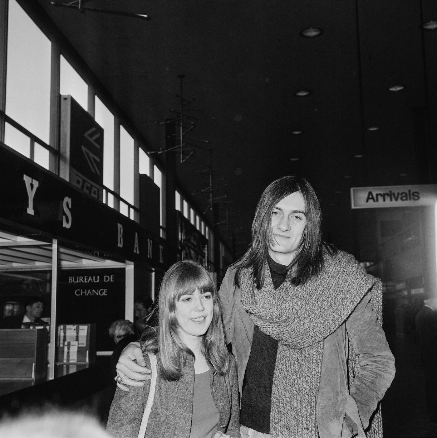 British Musician Mick Fleetwood Of Fleetwood Mac With His Girlfriend, Model Jenny Boyd (Sister Of Pattie Boyd) At London Airport, 1970