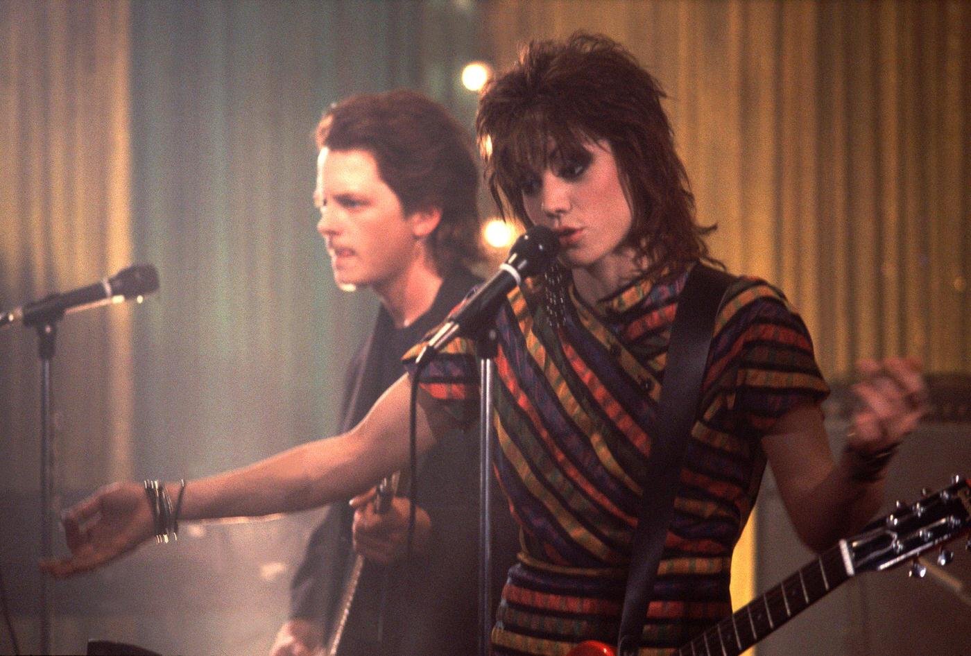 Joan Jett And Actor Michael J. Fox Onstage At The Thirsty Whale Bar During Filming Of The Movie 'Light Of Day', 1986