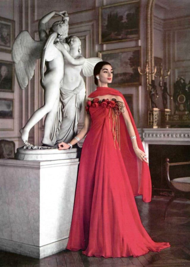 Jacky Mazel In Fiery Red Chiffon Gown, A Row Of Roses Borders The Draped Bodice, By Grès, Jewelry By Boucheron, Paris, 1956