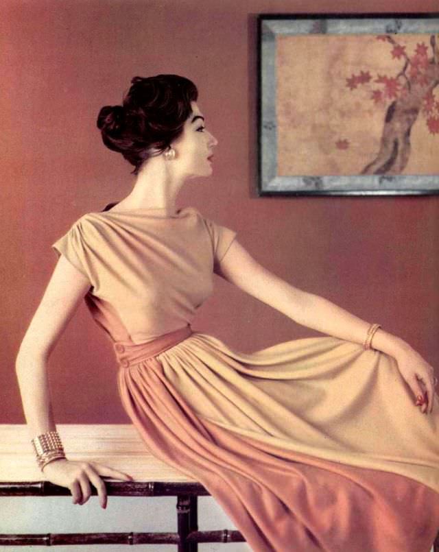 Simone D'Aillencourt In Beige And Orange Jersey Dress, Bodice Is Gathered At The Shoulders And Buttoned Belt Holds Pleats In Front, By Grès, 1957
