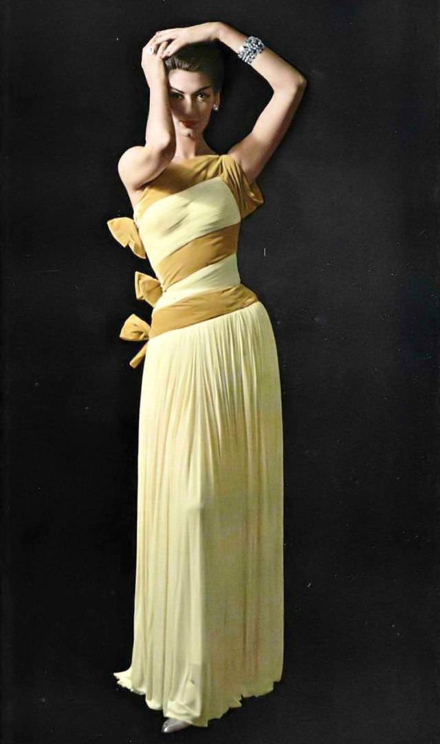 Simone D'Aillencourt In Fluid One-Shoulder Mousseline Jersey Gown Banded And Tied In Bows Of Velvet By Grès, Jewelry By Scémama, 1957