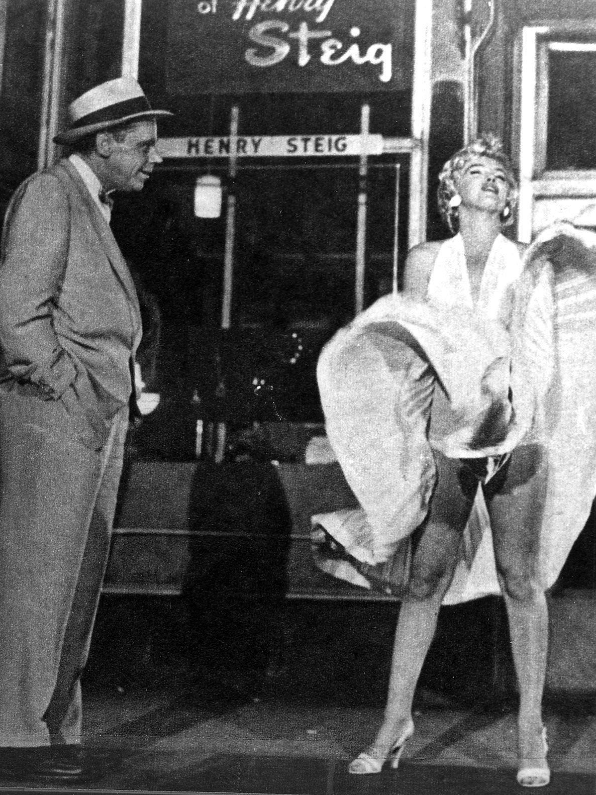 Marilyn Monroe With The Skirt Of Her White Dress Blowing As She Stands