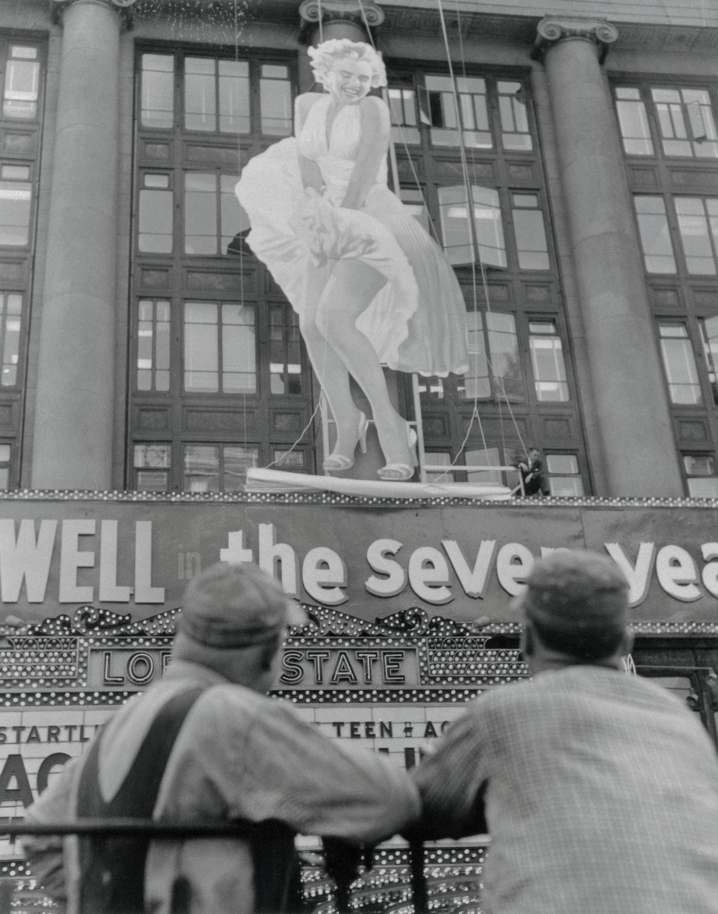 Marilyn Monroe Poster Installed. Spectators Gawk In Times Square As A Fifty-Two-Foot Figure Of Marilyn Monroe Is Erected On The Front Of Loew'S State Theatre.
