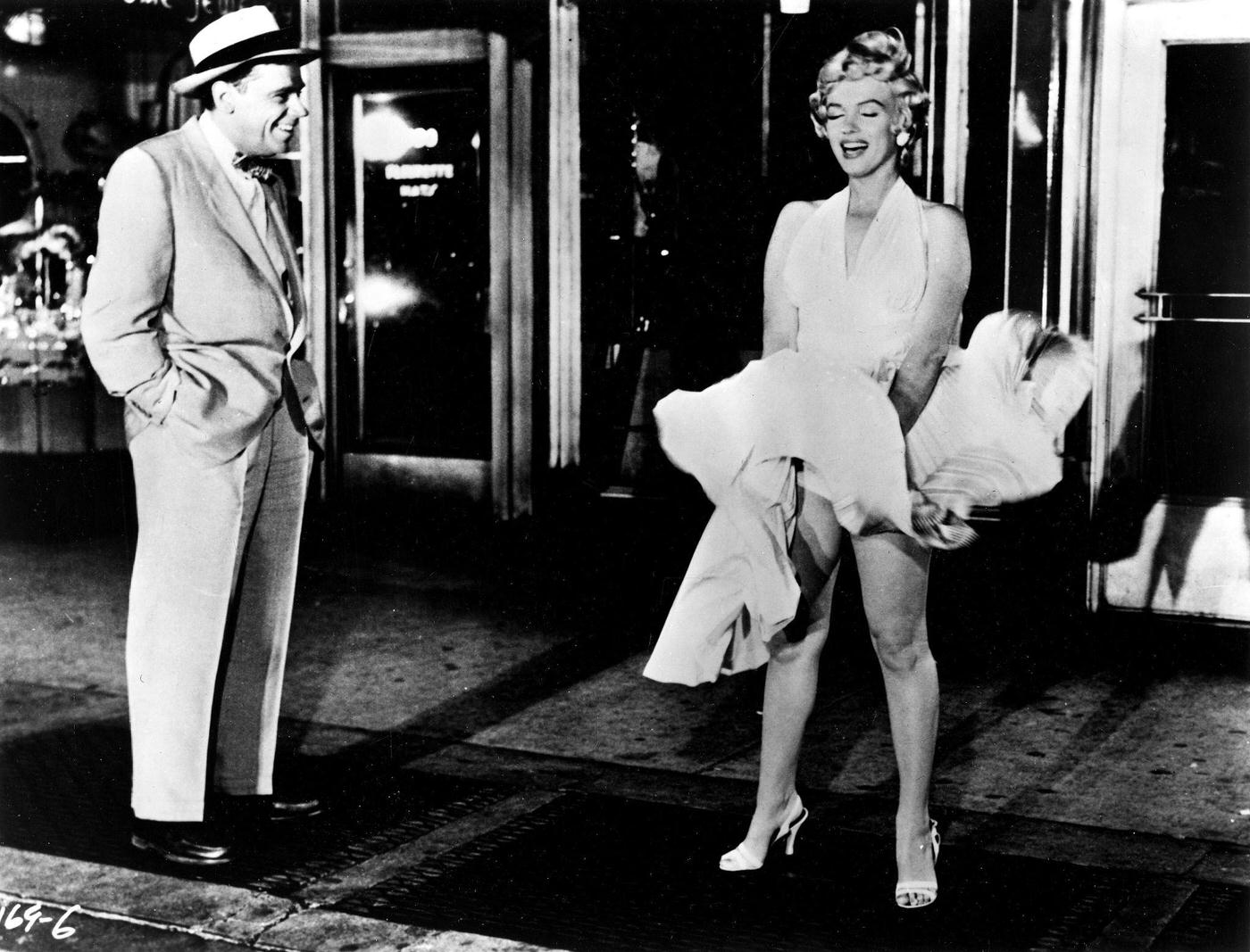 Marilyn Monroe With The Skirt Of Her White Dress Blowing As She Stands Over A Subway Grate At The Corner Of 51St Street And Lexington Avenue With Co-Star Tom Ewell In September, 1954
