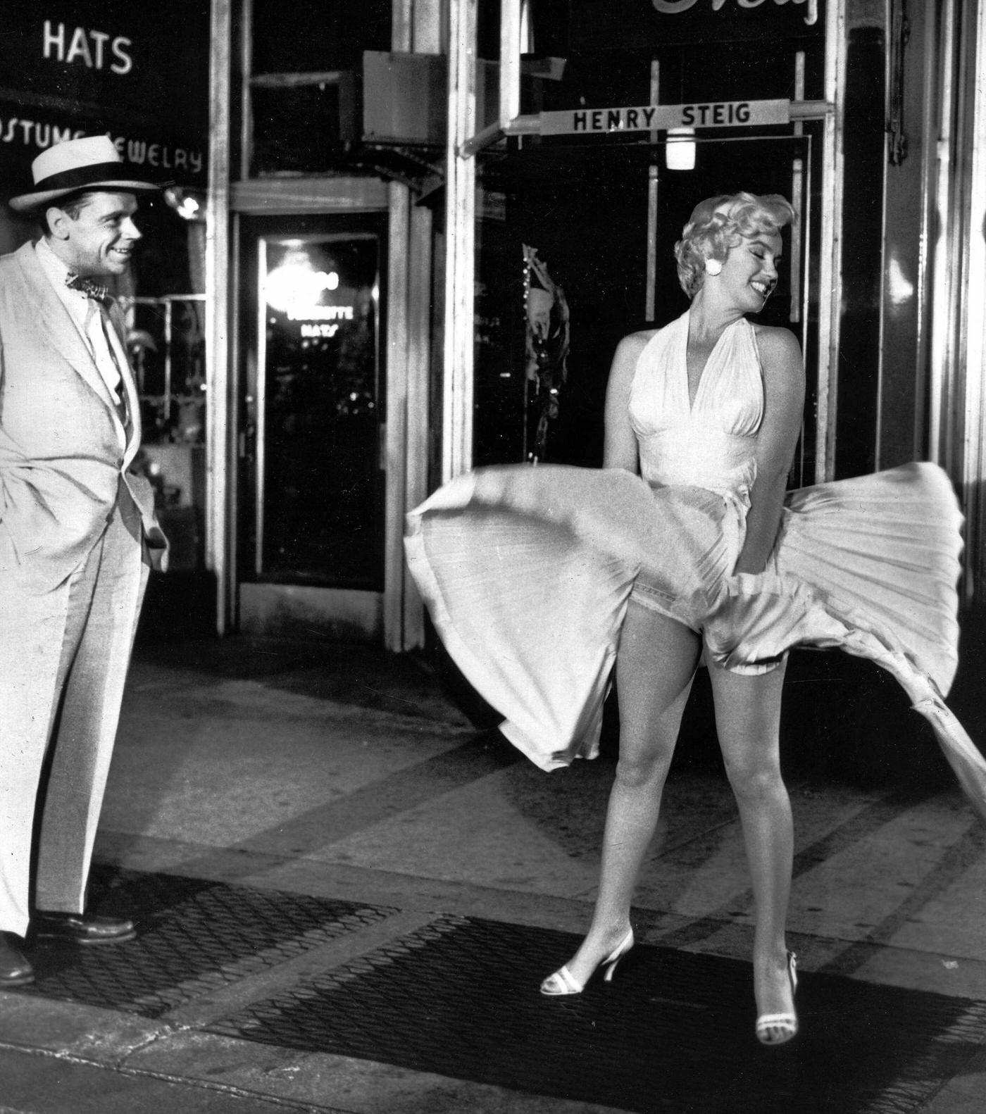 Marilyn Monroe With The Skirt Of Her White Dress Blowing As She Stands Over A Subway Grate At The Corner Of 51St Street And Lexington Avenue With Co-Star Tom Ewell In September, 1954