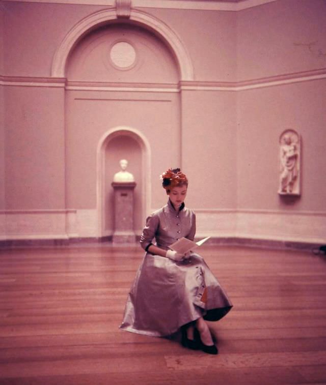 Sheila Kilgore Wears A Princess Coat-Dress Of Checked Stiff, Ridged Silk Lined In Red Taffeta With Jeweled Buttons And Half Belt In Back By Mollie Parnis, 1952