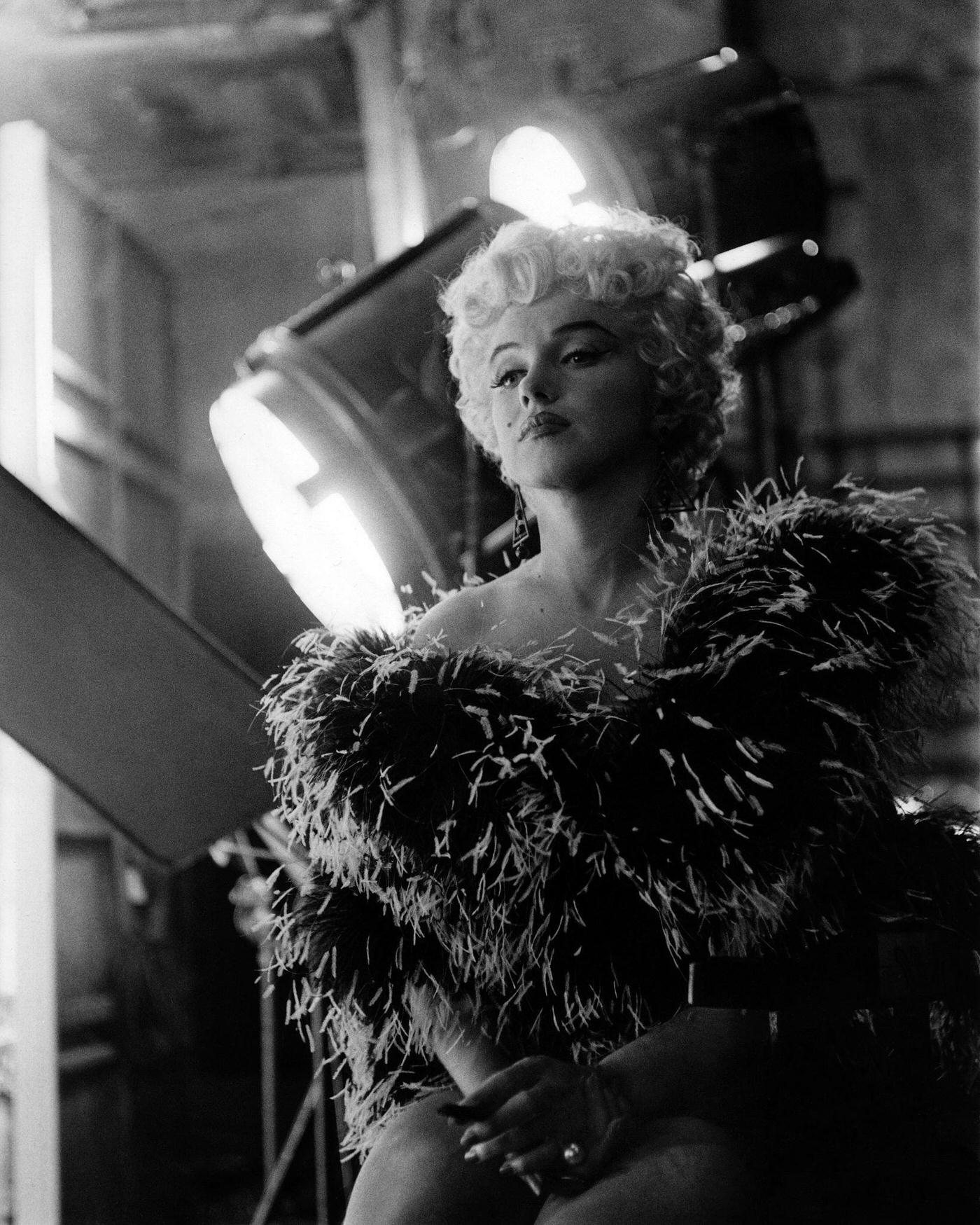 Marilyn Monroe Wearing A Feather Boa In Front Of Film Set Lights In 1954 During The Filming Of &Amp;Quot;The Seven Year Itch&Amp;Quot; In Los Angeles