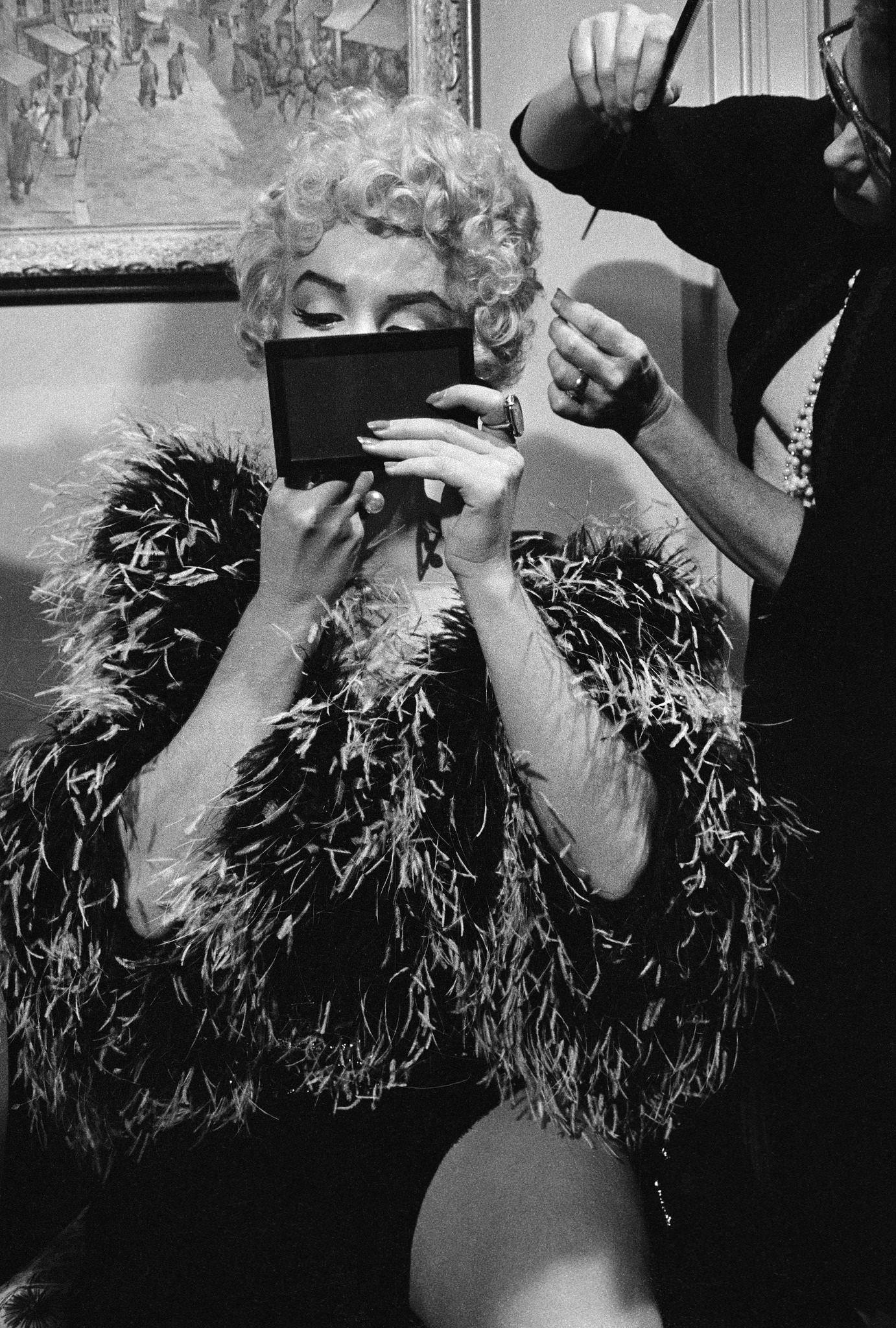 Marilyn Monroe Wearing A Feather Boa Puts On Makeup To Prepare For A Scene During The Filming Of &Amp;Quot;The Seven Year Itch&Amp;Quot; In 1954