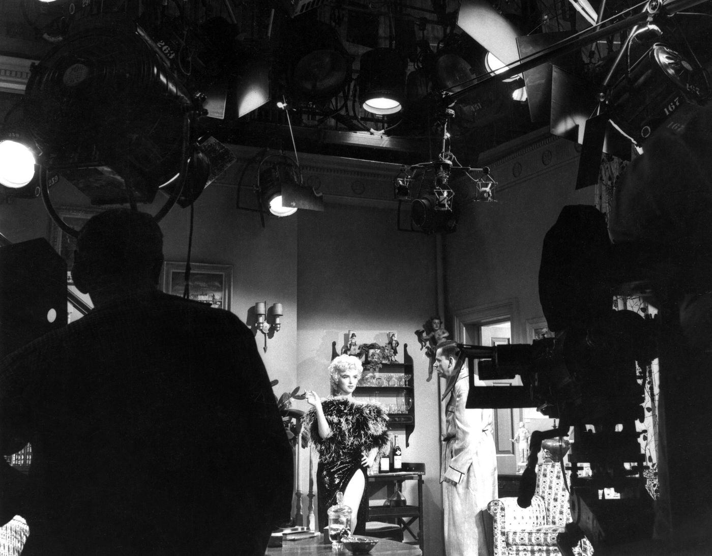 Marilyn Monroe Wearing A Feather Boa With Co-Star Tom Ewell With Cameras And Equipment In The Foreground During The Filming Of &Amp;Quot;The Seven Year Itch&Amp;Quot; In 1954