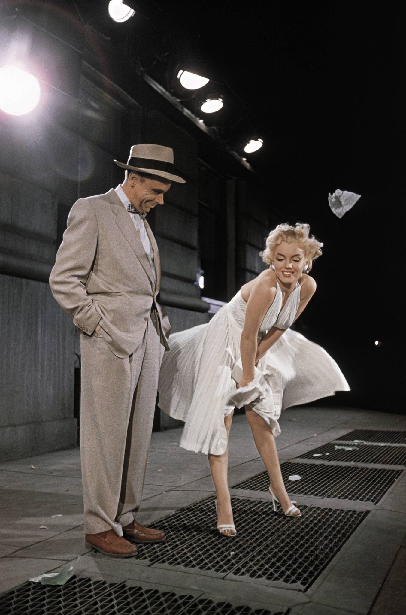 Marilyn Monroe Standing Over A Subway Grate With Her White Dress Blowing And Co-Star Tom Ewell Looking On In 1954 During The Filming Of &Amp;Quot;The Seven Year Itch&Amp;Quot;