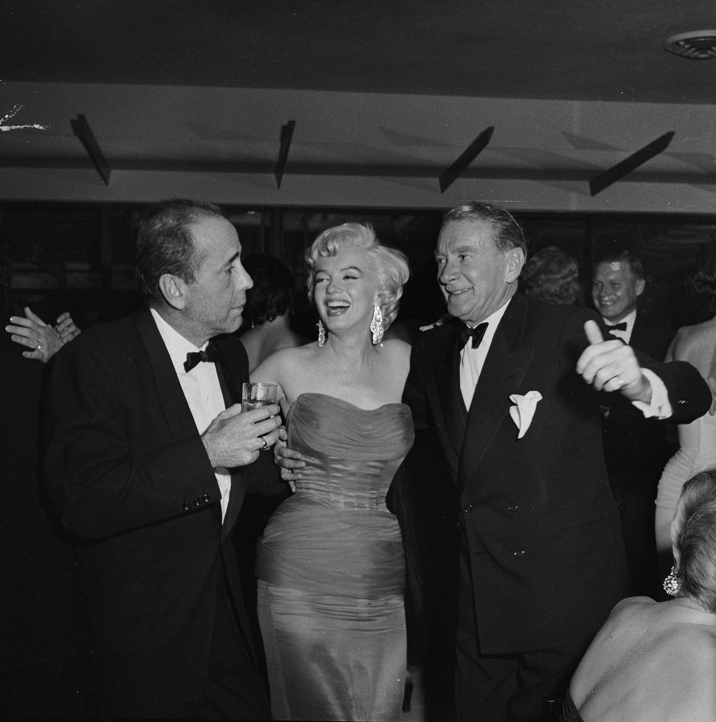 Marilyn Monroe With Actors Humphrey Bogart And Clifton Webb At The Wrap Party For The Filming Of &Amp;Quot;The Seven Year Itch&Amp;Quot; At Romanoff'S Restaurant In 1954