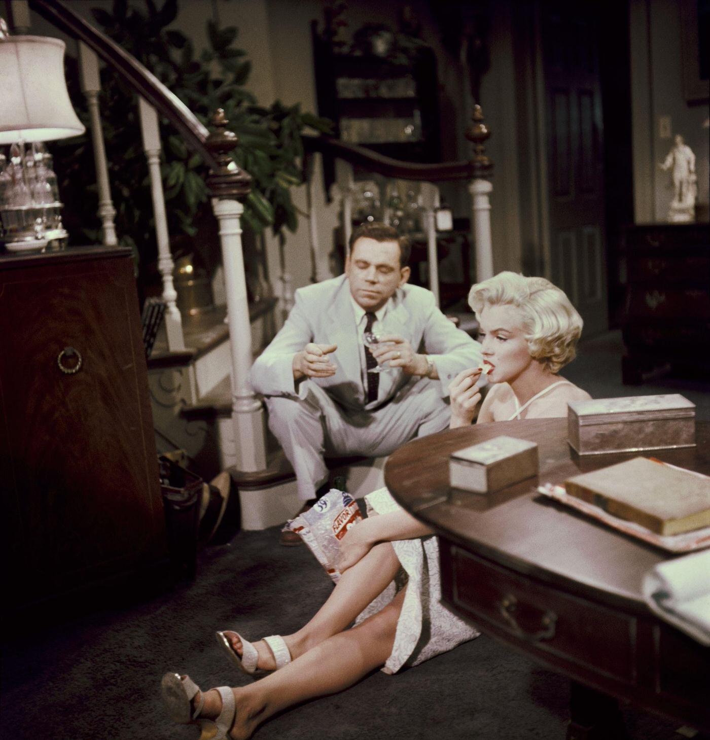 Marilyn Monroe Eats Potato Chips And Drinks Champagne Sitting On The Floor With Co-Star Tom Ewell In 1954 During The Filming Of &Amp;Quot;The Seven Year Itch&Amp;Quot;