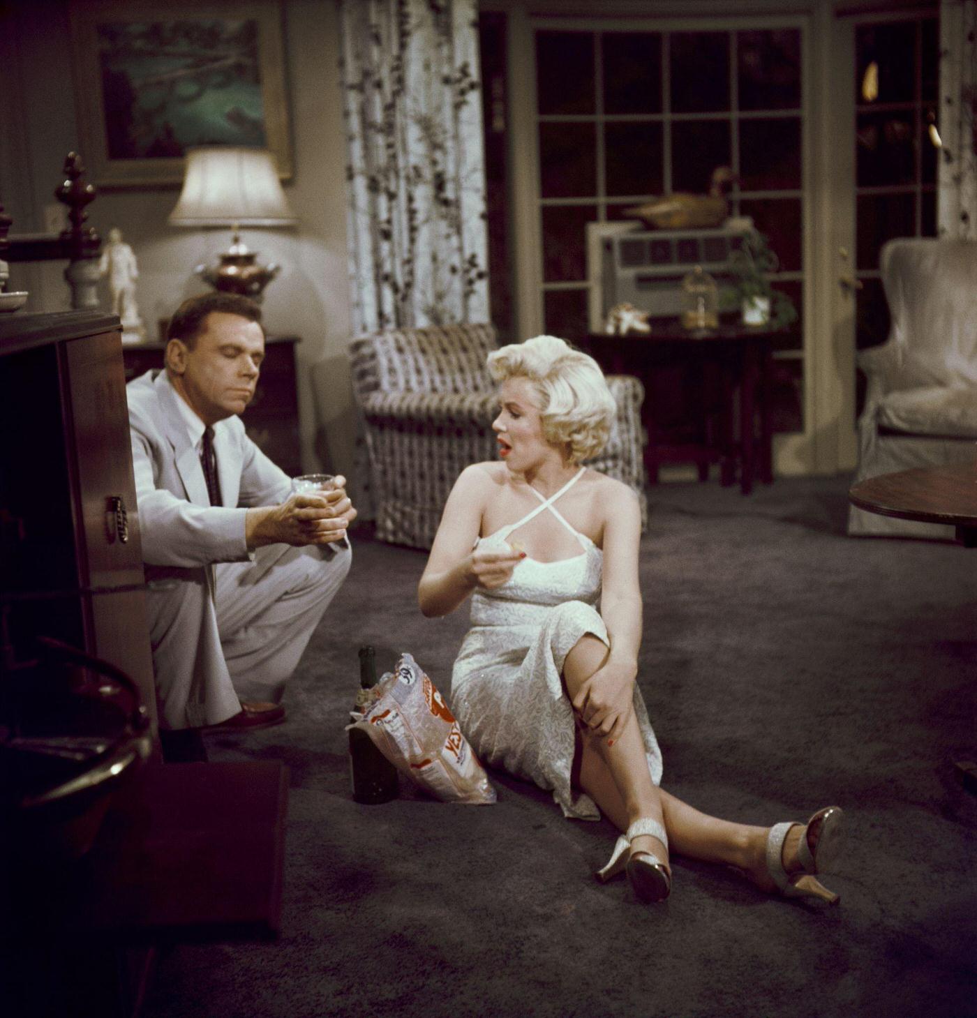 Marilyn Monroe Eats Potato Chips And Drinks A Champagne Sitting On The Floor With Co-Star Tom Ewell In 1954 During The Filming Of &Amp;Quot;The Seven Year Itch&Amp;Quot;