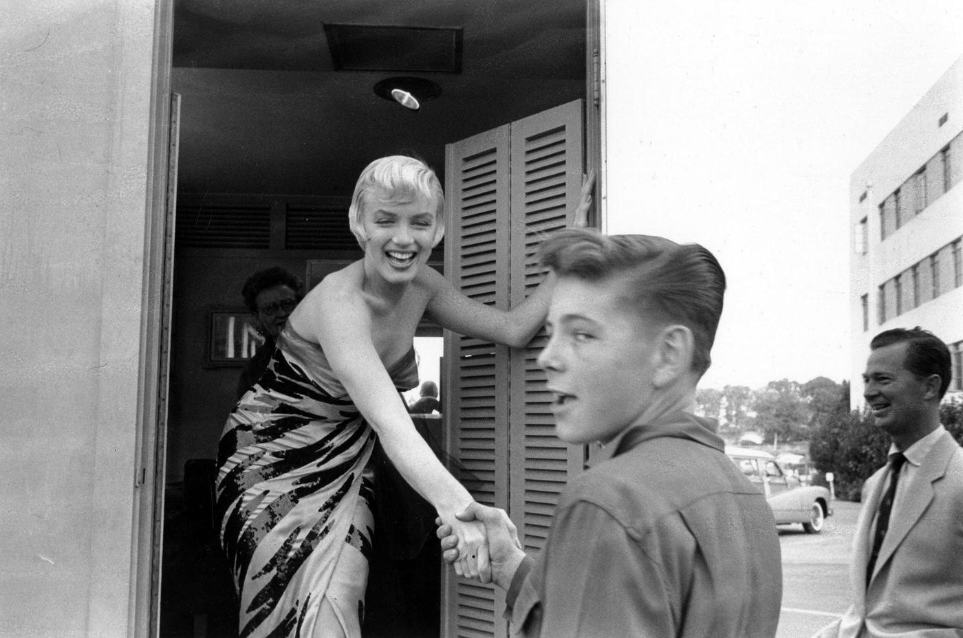 Marilyn Monroe Wearing A Tiger-Striped Dress Shakes Hands With A Boy On Set In 1954 During The Filming Of &Amp;Quot;The Seven Year Itch&Amp;Quot;